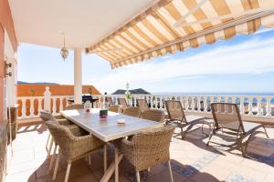 ChayofaにあるViVaTenerife - Villa with pool, jacuzzi and sea viewの海を望むパティオ(テーブル、椅子付)