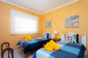 A bed or beds in a room at ViVaTenerife - Villa with pool, jacuzzi and sea view