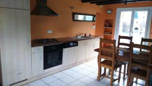 a kitchen with a sink and a stove top oven at Chalet pour amoureux de la nature avec vue sur le lac de Retournemer in Xonrupt-Longemer