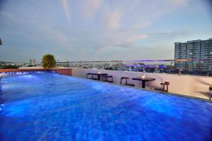 a large swimming pool on the roof of a building at Aiden Saigon Hotel in Ho Chi Minh City