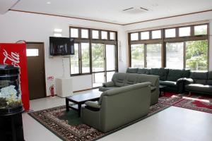 a living room with couches and a table at Hotel Tulip Ishigakijima in Ishigaki Island