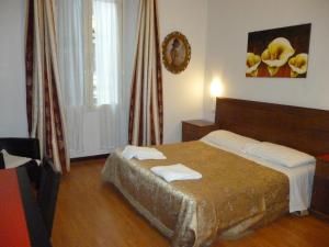 a bedroom with a bed with two towels on it at Hotel Gloria in Rome