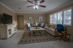 a living room with a couch and a tv at Chic Private Pool Home Minutes to Bonita Beaches in Bonita Springs