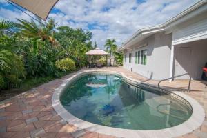 a swimming pool in the backyard of a house at Chic Private Pool Home Minutes to Bonita Beaches in Bonita Springs