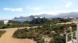 arial view of a house with mountains in the background at Reddoor Studio in Pringle Bay