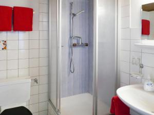 a shower with a glass door in a bathroom at Alba in Saas-Fee