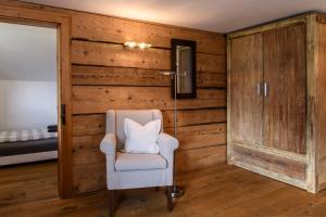 a white chair in a room with wooden walls at Chalet "Altes Schulhaus" in Schruns