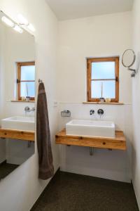 a bathroom with two sinks and a mirror at Chalet "Altes Schulhaus" in Schruns