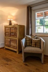 a living room with a chair and a dresser at Chalet "Altes Schulhaus" in Schruns +27 photos
