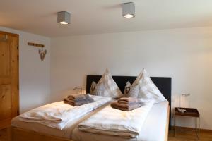 a bedroom with a bed with towels on it at Chalet "Altes Schulhaus" in Schruns
