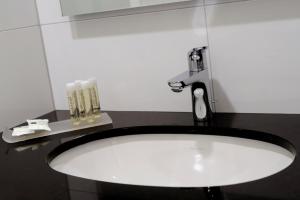 a sink in a bathroom with a faucet at Hotel Trix in Arnhem +34 photos