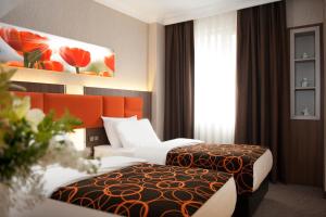 Postel nebo postele na pokoji v ubytování Birbey Hotel