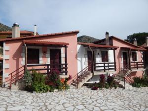 a pink house with flowers in front of it at Mountain Ηouse in Arcadia in Vitina