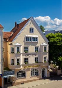 a large white building with a sign on it at CityHotel Kempten in Kempten