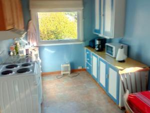 cocina con estufa blanca y ventana en Your own house in Orkanger, en Orkanger