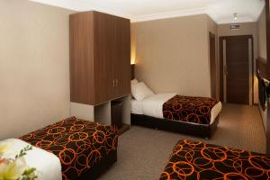Postel nebo postele na pokoji v ubytování Birbey Hotel