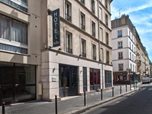 a building with a sign on it on a street at Hôtel des Métallos in Paris
