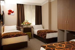 Postel nebo postele na pokoji v ubytování Birbey Hotel