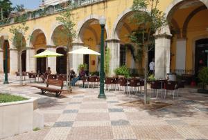 an empty courtyard with tables and chairs with umbrellas at Silves Historical House in Silves