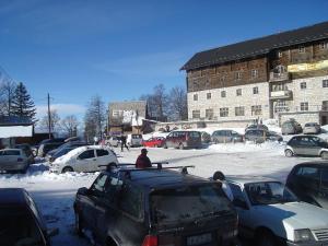 a group of cars parked in a parking lot at Apartmani Etno in Jahorina