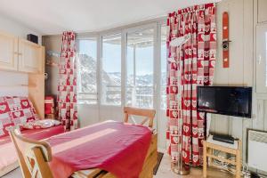 a room with a bed and a window and a television at Residence Les Ruches - maeva Home in Avoriaz