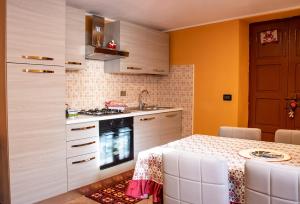 a kitchen with a table and a stove top oven at Casa la foriana in Carema