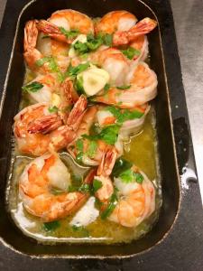 a tray filled with shrimp and greens on a table at Petit Hôtel de Chaumont in Chaumont-de-Pury