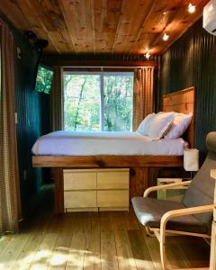 a bedroom with a bed and a window at Barefoot Hills in Dahlonega