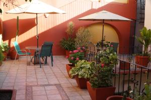 a patio area with a patio table and a patio umbrella at Parador San Agustin in Oaxaca City