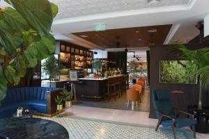 a lobby of a restaurant with chairs and a bar at Hotel Eco Boutique Bidasoa in Santiago