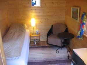 a room with two beds and a desk and a table at Your cabin in Trondheim in Tiller