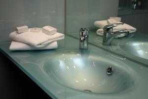 a bathroom sink with towels and a faucet at Station House Hotel Letterkenny in Letterkenny