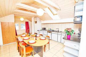 a kitchen with a table and chairs in a kitchen at Central Park Holiday apartment in Interlaken