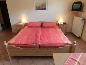 a bedroom with a large bed with a red comforter at Weingut Hirschen Enkircherweg in Burg an der Mosel