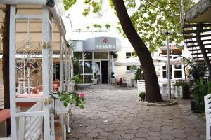 a building with a tree in the middle of a street at Hotel Trakia in Plovdiv +6 photos