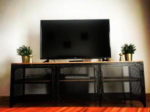 a flat screen tv sitting on top of a entertainment center at SKI & NATURE JAVALAMBRE in Camarena de la Sierra