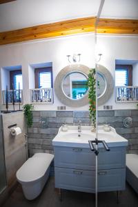 a bathroom with a sink and a toilet and a mirror at “Moment s“ pool house Trakoscan in Trakošćan