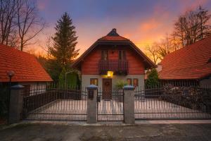 a house with a fence in front of it at “Moment s“ pool house Trakoscan in Trakošćan