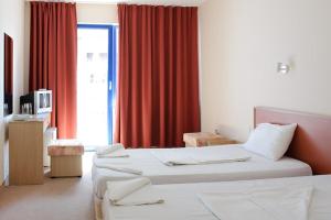 Hotel Nadia tesisinde bir odada yatak veya yataklar