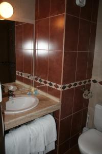 a bathroom with a sink and a toilet at Hotel Nadia in Primorsko