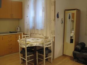 a kitchen with a table and chairs in a room at Apartment Nadejda in Varna City