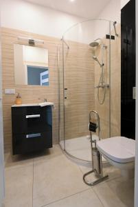 a bathroom with a shower and a sink and a toilet at Poduszka Apartamenty Zdrojowe in Nałęczów +95 photos