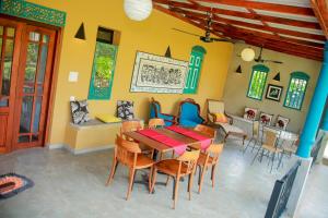 a dining room with a table and chairs at Kurumba Villas in Bentota