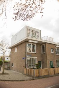 a large brick building on a street at B&B Gabriela Amsterdam in Amsterdam