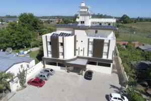 an aerial view of a white house with a lighthouse at Terra do Chimarrão Hotel in Venâncio Aires