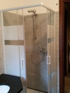 een douche in een badkamer met een glazen deur bij Morbegno house in Morbegno