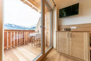 Televízia a/alebo spoločenská miestnosť v ubytovaní agriturismo Lüch Picedac