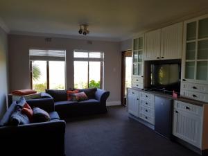 a living room with a couch and a tv at 20A Castleton in Plettenberg Bay