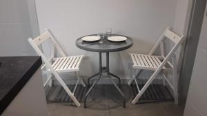 a small table and two chairs in a room at PRZYSTANEK KATOWICE Mariacka 26 in Katowice