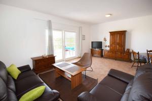 a living room with a couch and a table at Wish Apartments in Poreč